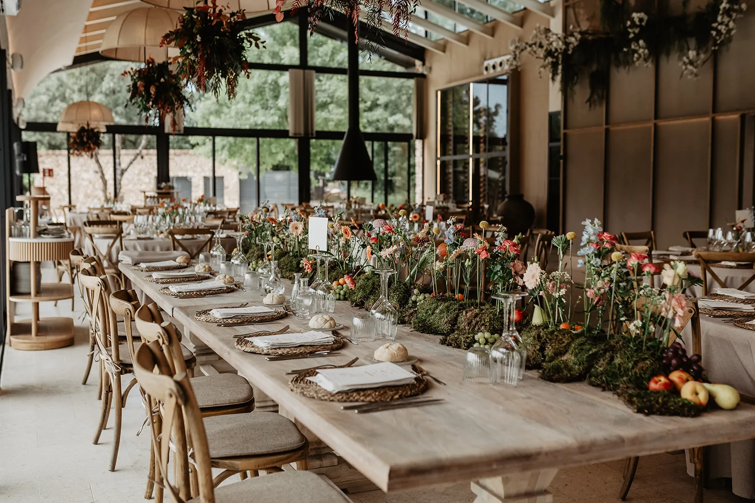 Mesa larga con decoración natural y flores de temporada. Bodas en Huellas del Tiétar
